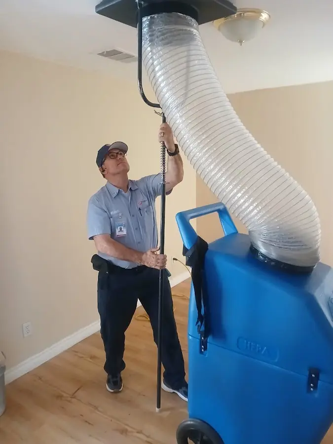 Furnace Tune-Up technician using HEPA equipment in Coolbaugh